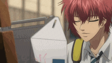 a red haired anime character with his eyes closed in front of a box