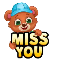 a teddy bear wearing a blue hat is holding up a sign that says miss you