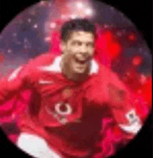 a man in a red jersey is standing in a circle and smiling .