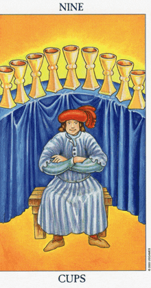 a tarot card shows a man sitting on a bench in front of a table of gold cups