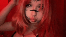 a girl with red hair and a mustache is making a face .