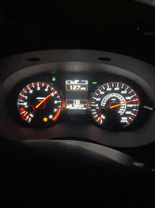 a close up of a car 's dashboard showing the speedometer at 127 mph