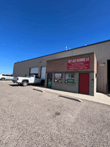 a tony 's auto mechanic llc building with a white truck parked in front of it