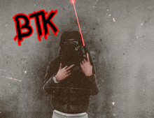 a man in a black hoodie with a red btk written on the top