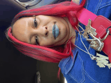 a woman with red hair is wearing a denim jacket and a pink belt