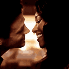 a man and a woman are kissing each other and smiling .