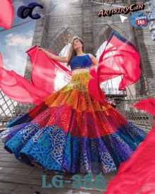 a woman in a colorful dress is standing in front of a bridge and a sign that says artistry can