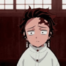 a close up of a person 's face with a sad look on his face .