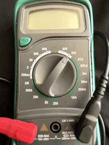 a digital multimeter with a hold button on the top