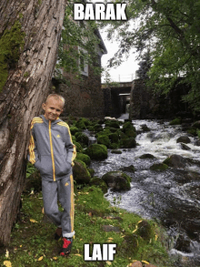 a young boy leans against a tree in front of a river with the name barak on the bottom