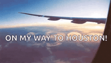 an airplane is flying in the sky with the words " on my way to houston "