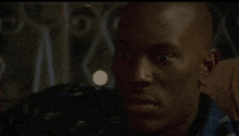 a close up of a bald man 's face in a movie .