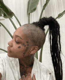 a woman with a tattoo on her face says love