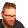 a man with a beard and glasses is looking at the camera .