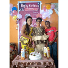 a group of people standing in front of a sign that says " happy birthday our sweet mommy "