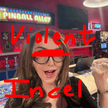 a woman wearing glasses stands in front of a pinball alley arcade machine