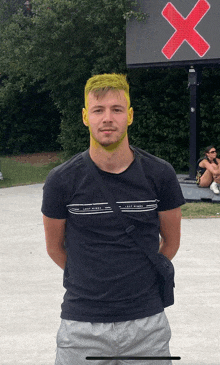 a man with yellow hair and a black shirt that says lost riders