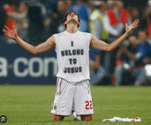 a soccer player wearing a shirt that says ' i belong to jesus ' on it