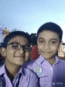 two young boys are posing for a picture with the date of december 18th on the bottom