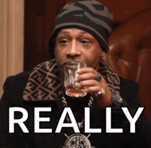 a man is drinking a glass of whiskey with the word really behind him