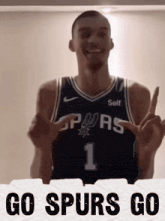 a basketball player with the number 1 on his jersey is giving a peace sign