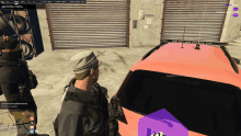 a screenshot of a video game shows a man standing next to a car with the number 21 on the back