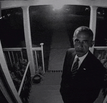 a black and white photo of a man in a suit and tie