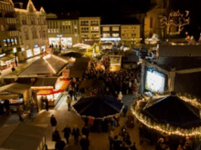 a crowd of people are gathered in a market at night