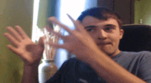 a man sitting in a chair with his hands up
