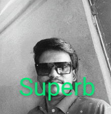 a man wearing sunglasses and a shirt with the word superb written on it