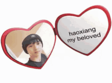 a heart shaped mirror with the words haoxiang my beloved