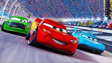 a group of cars from the movie cars are racing on a track .