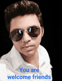 a man wearing sunglasses says " you are welcome friends " in blue