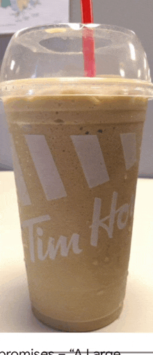 a tim hortons cup with a red straw in it