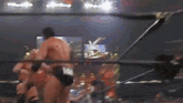 a blurry picture of a wrestling ring with a few wrestlers