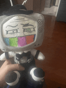 a stuffed animal has a drawing of a tv on it