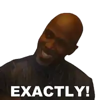 a bald man with a beard is smiling with the words exactly behind him