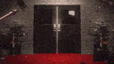 a red carpet leading to a door with a picture of a stuffed animal inside