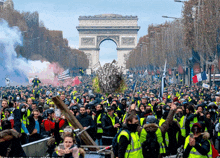 a crowd of people are gathered in front of a large archway