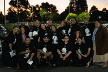 a group of people are posing for a picture and one of their shirts says ' hawaii '