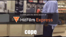 a man standing in front of a sign that says hitfilm express cope