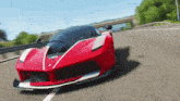 a red sports car is driving down the road