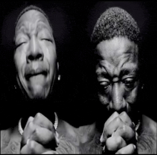 a black and white photo of a man crying and praying