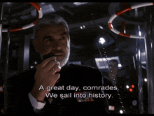 a man talking on a walkie talkie with the words " a great day comrades we sail into history " below him