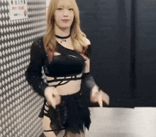 a woman in a black crop top and shorts is dancing .