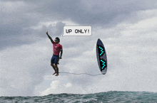 a man is riding a wave with a speech bubble that says up only