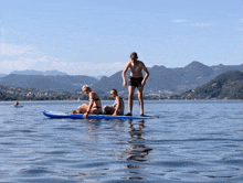 a group of people on a paddle board in a lake