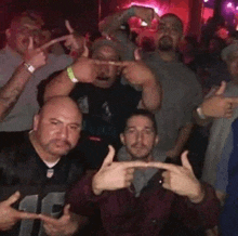 a group of men are posing for a picture in a club .