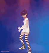 a girl in a white dress and striped knee high socks is dancing on a stage