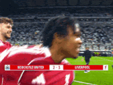 a soccer game between newcastle united and liverpool is underway